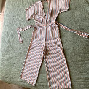 Stripped jumpsuit with pockets and back cutout. Minor pulled strings